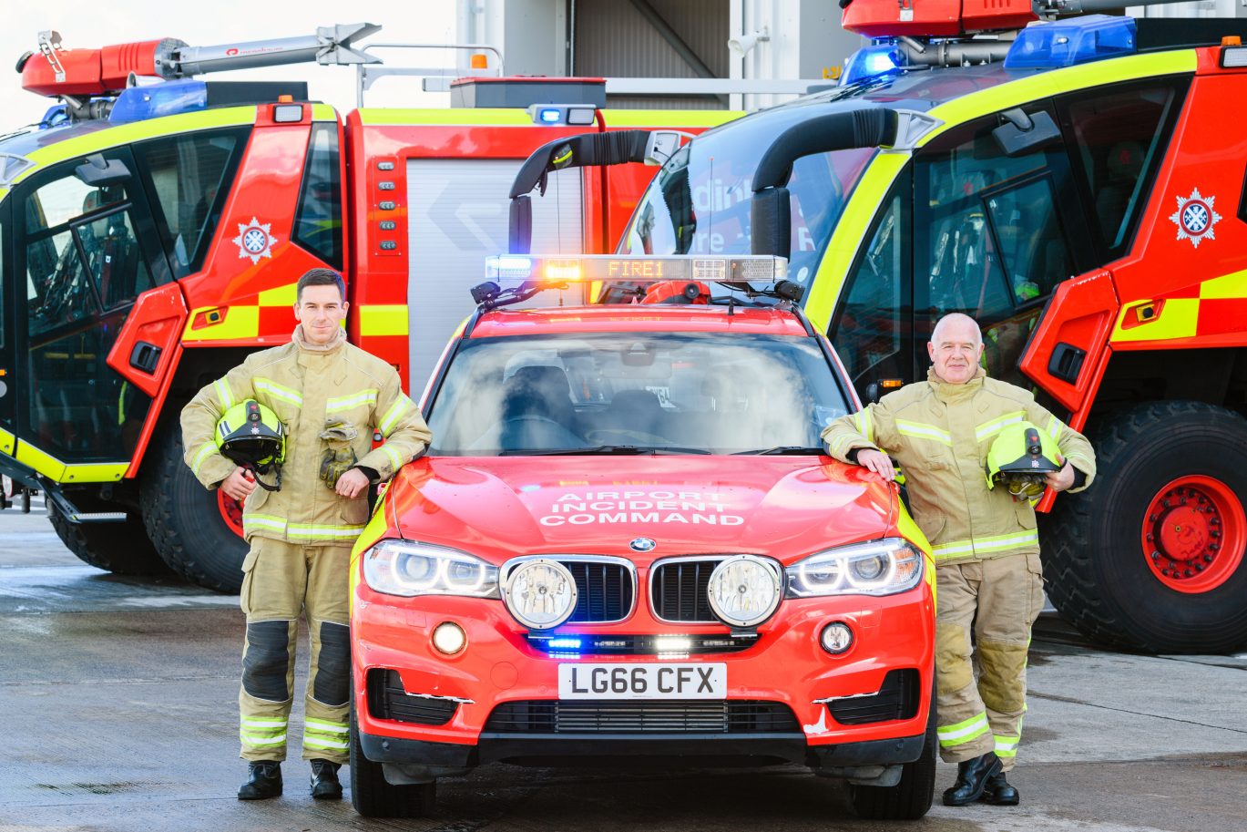 Men standing by fire vehicle