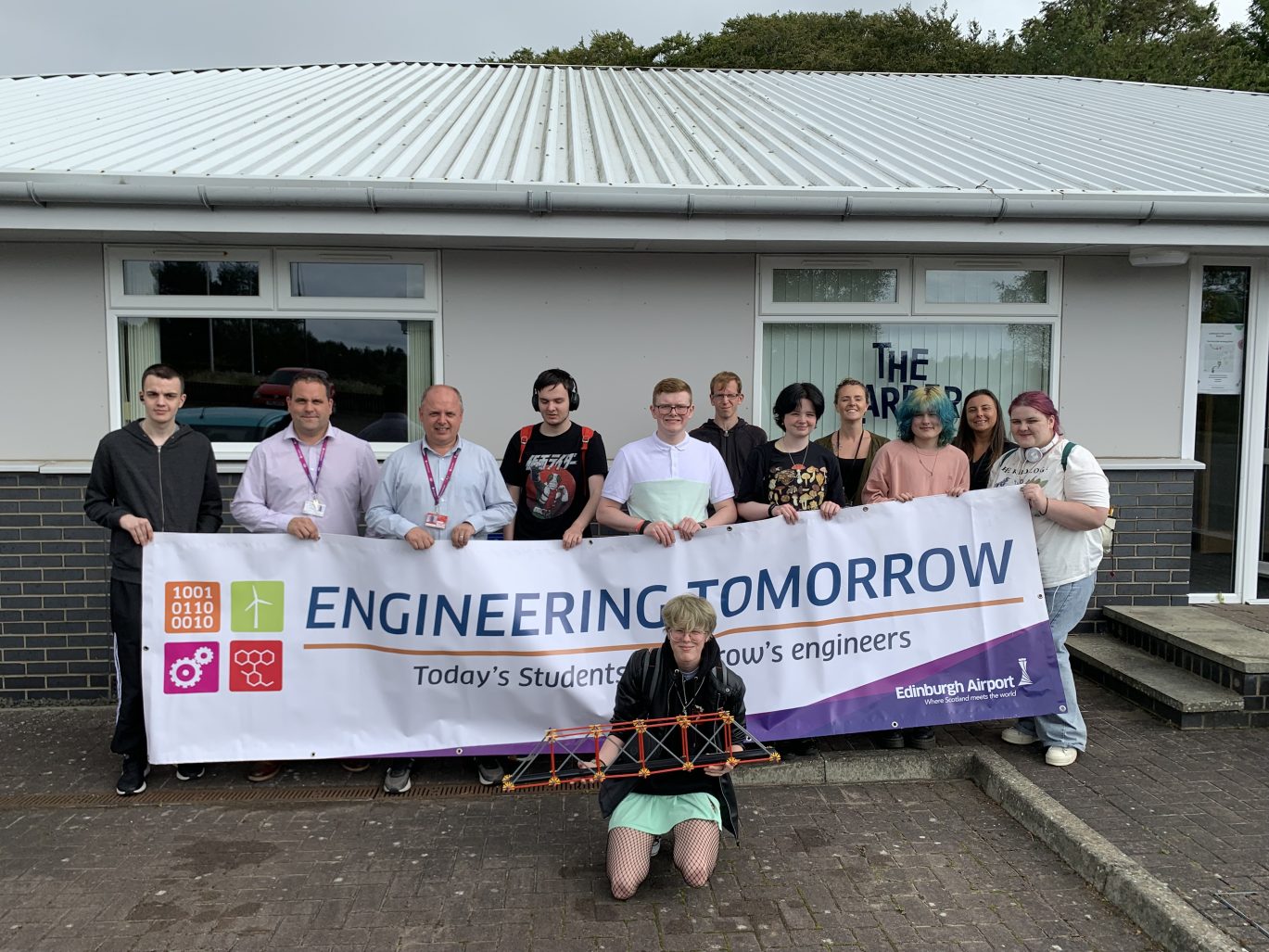 Group of young people holding banner saying Engineering Tomorrow