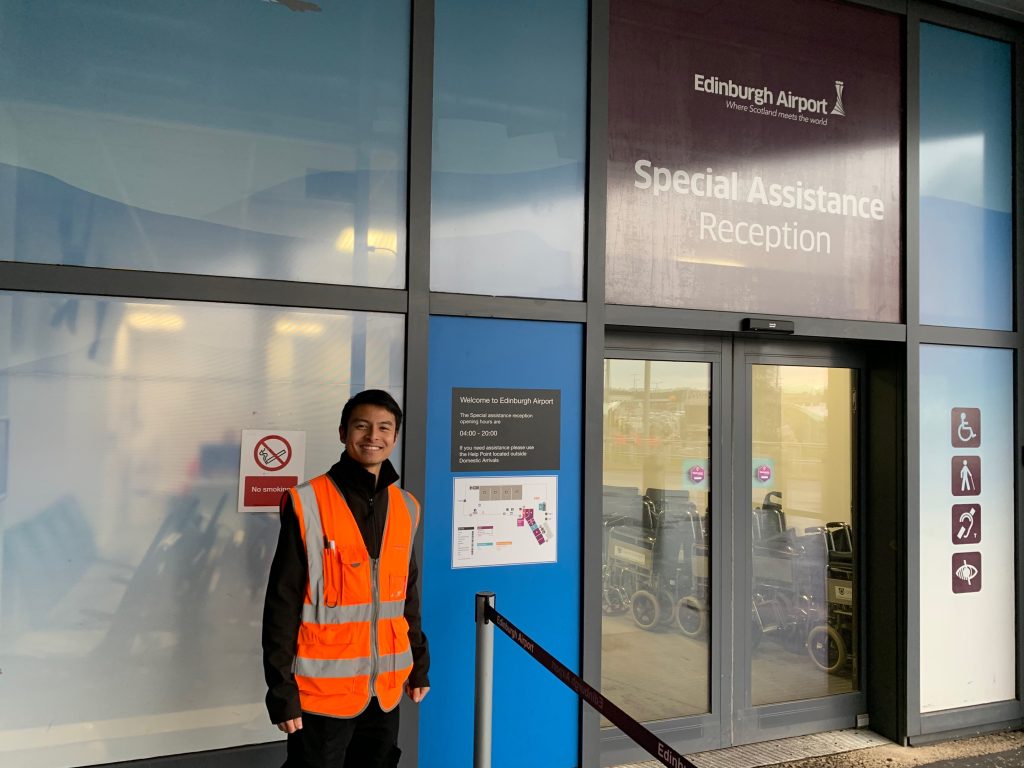 Man standing in front of special assistance reception 