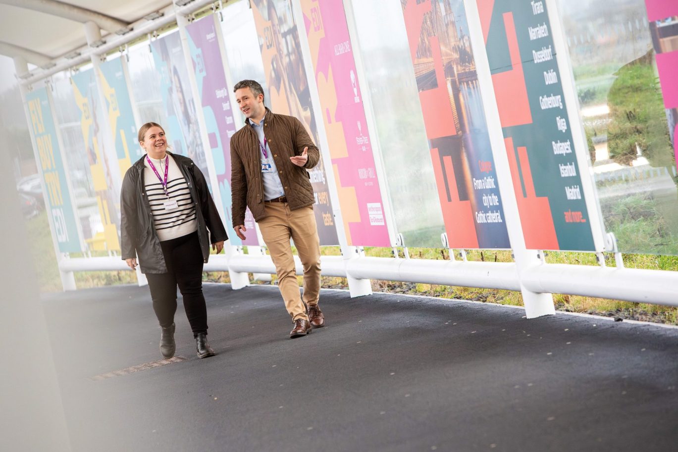 Two colleagues walking outside of the terminal chatting